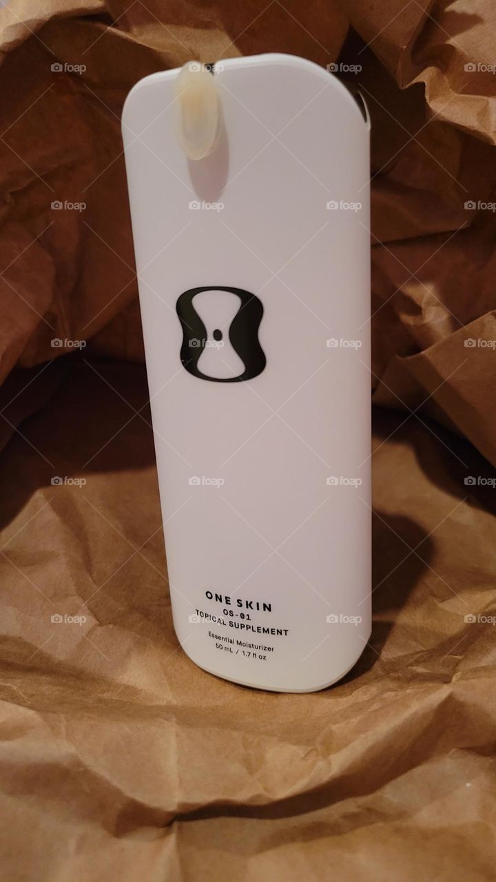 One Skin OS-1 face anti-aging topical supplement for skin health on neutral background