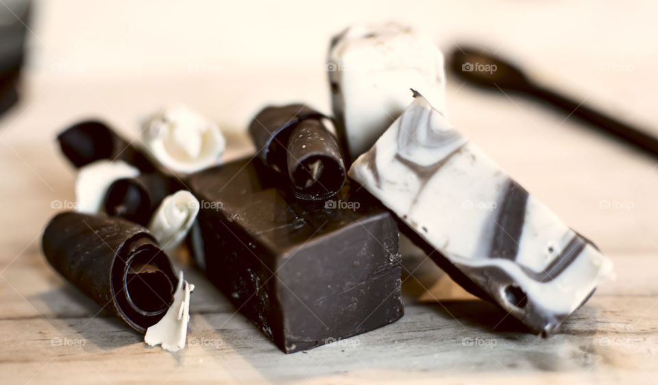 Dark chocolate and white chocolate pieces in different shapes and textures and vanilla chocolate fudge in kitchen gourmet artisanal epicure chocolate photography 
