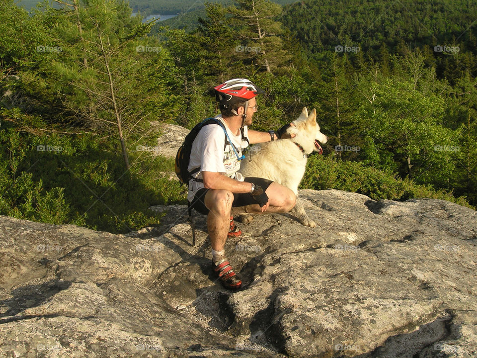 Mountain biker takes a break with his dog in the mountains