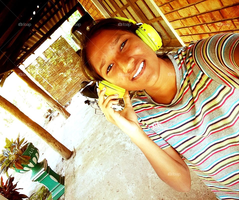 A girl listening songs on headphone
