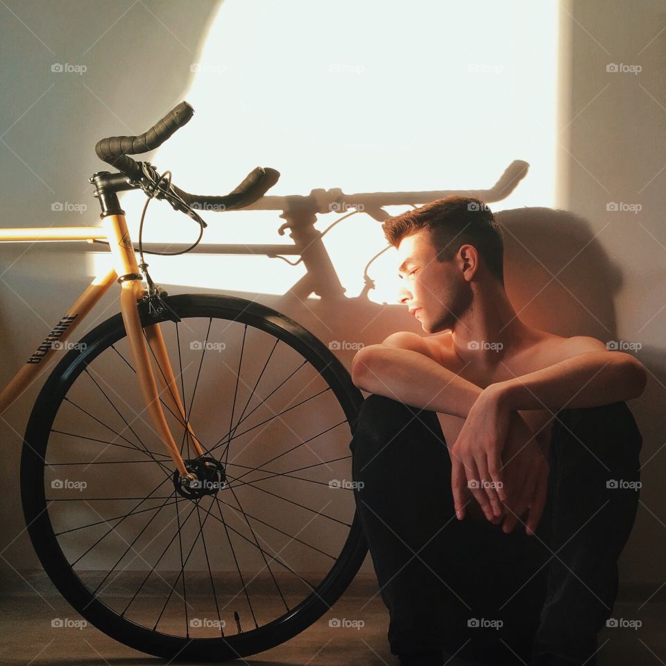 Sunset in a window with bike and cyclist