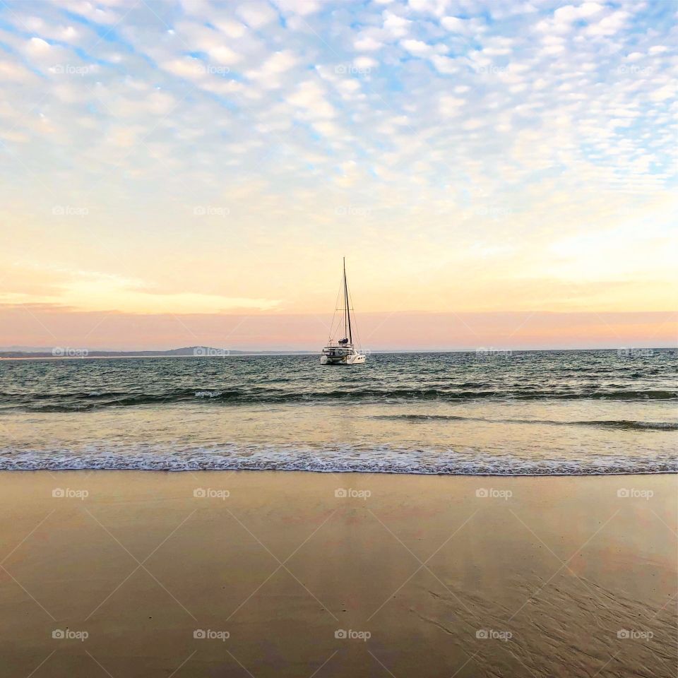 Sailing away. Early morning at the beach 