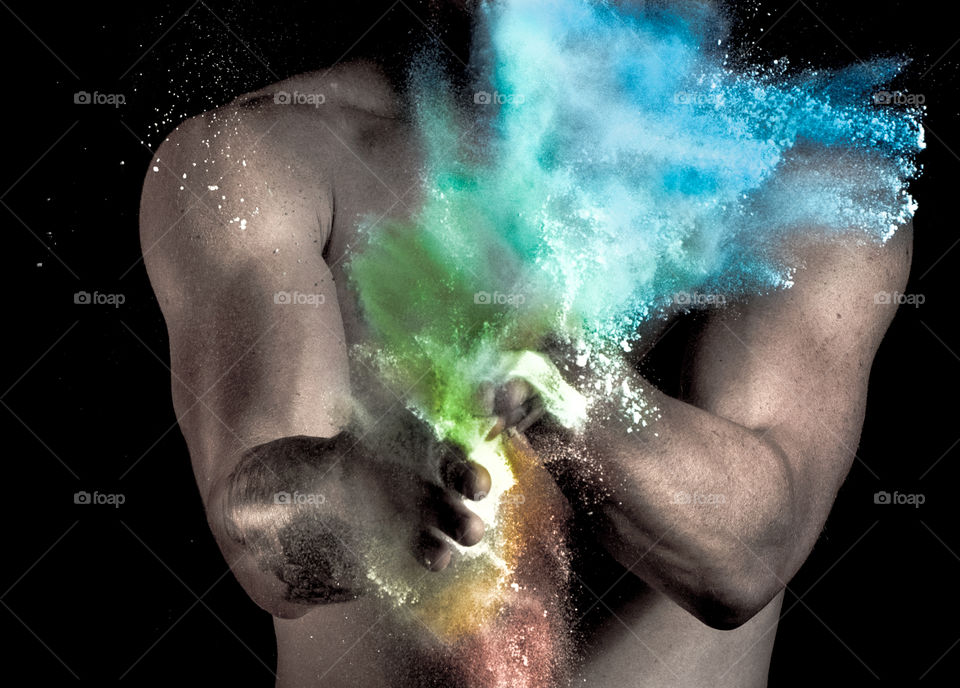 colorful powder on the backgroud of athletic body