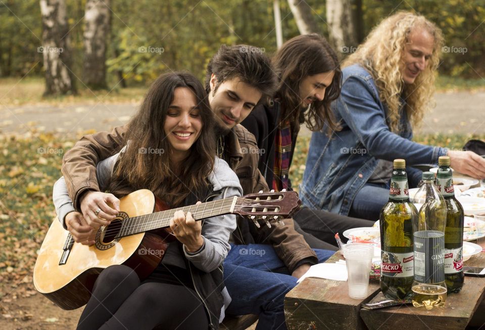 Friends meeting outdoor, playing music