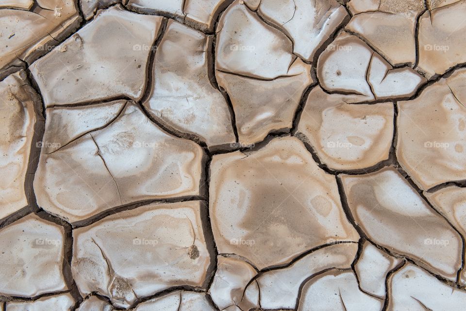 Patterns of dry cracked mud . Dry cracked mud in the Atacama Desert, Chile