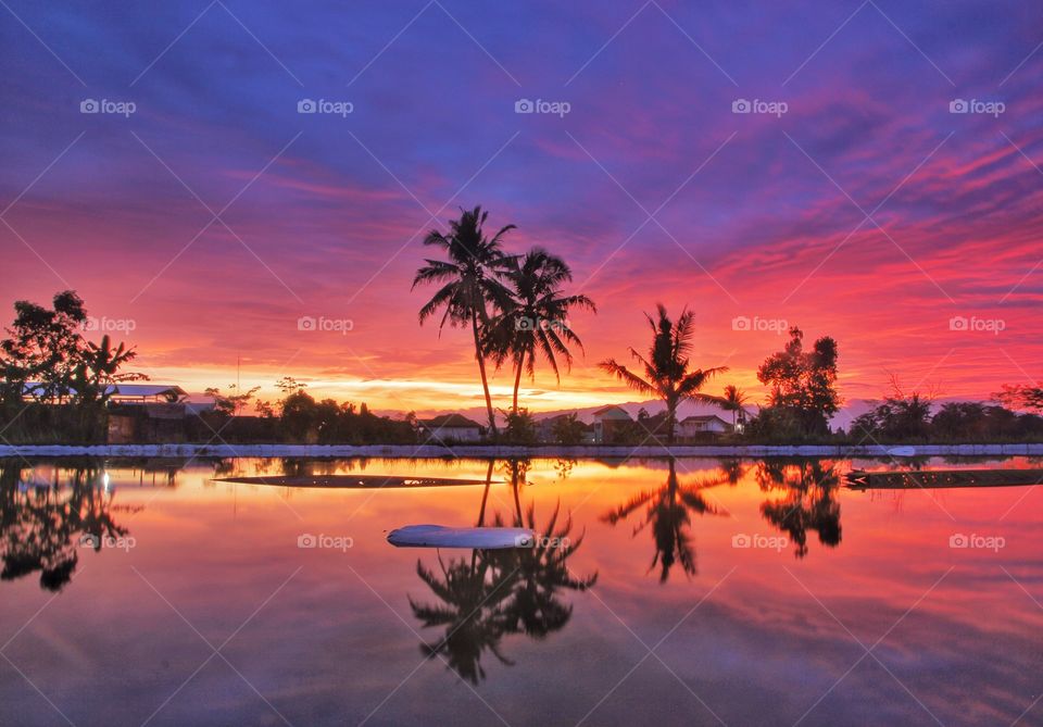 Dramatic sky reflected on lake during sunset