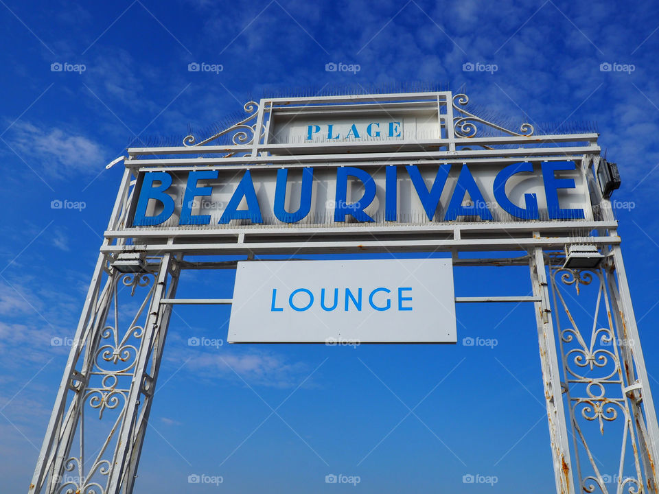 Blue sky above the Beau Rivage Beach sign on the Promenade des Anglais in Nice , France.