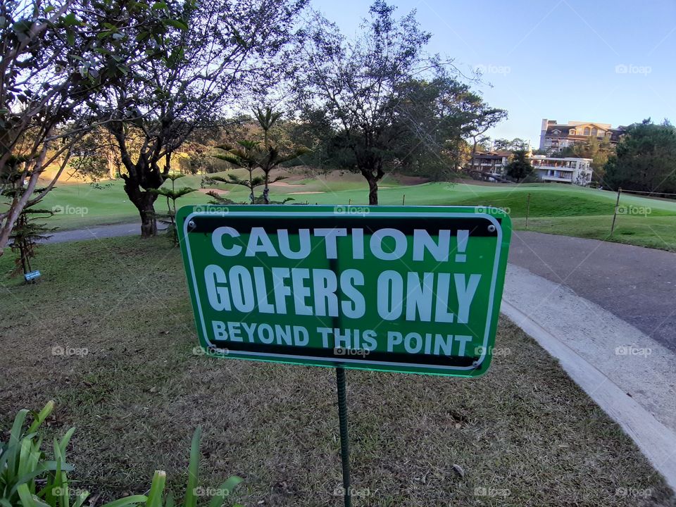 Caution sign at the golf course.