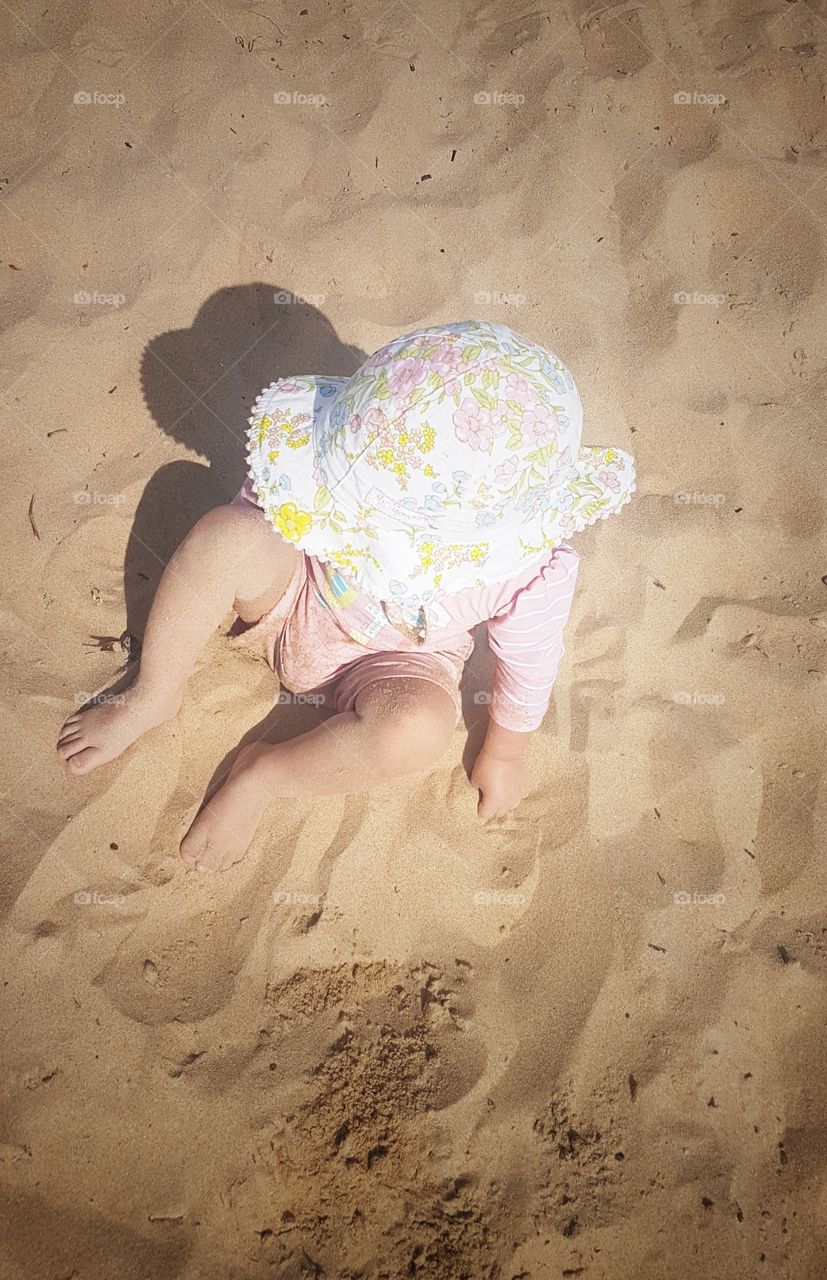 Little a girl Playing in the sand