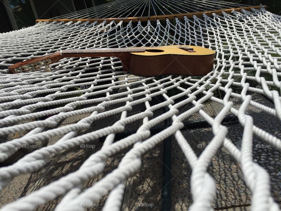Ukulele sits atop a hammock 