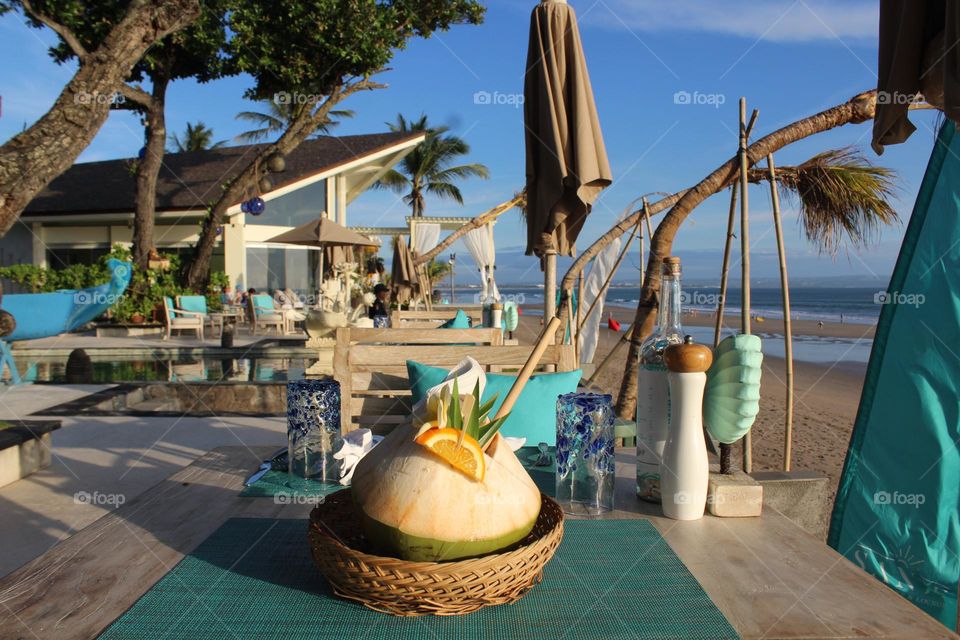 Panoramic coastline views and fancy coconuts in Seminyak resort area of Bali island. 