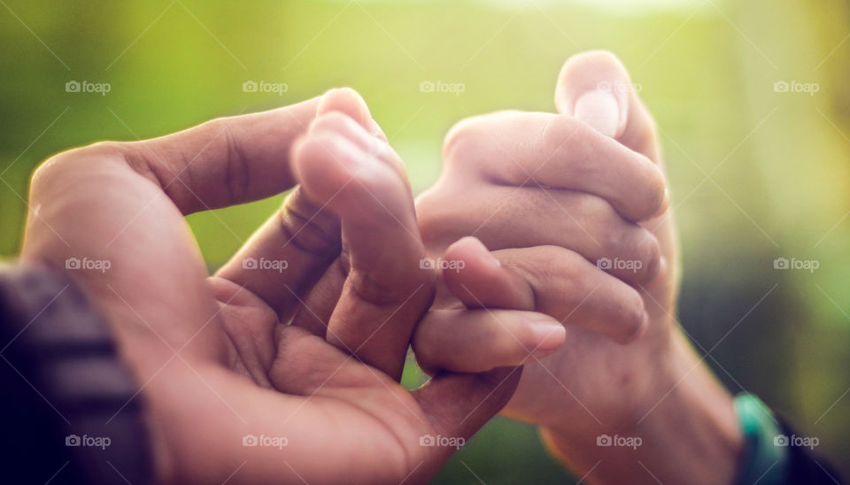 Sealing the deal with the oldest, sweetest agreement. Perfect shot for themes of commitment, friendship, and childhood memories