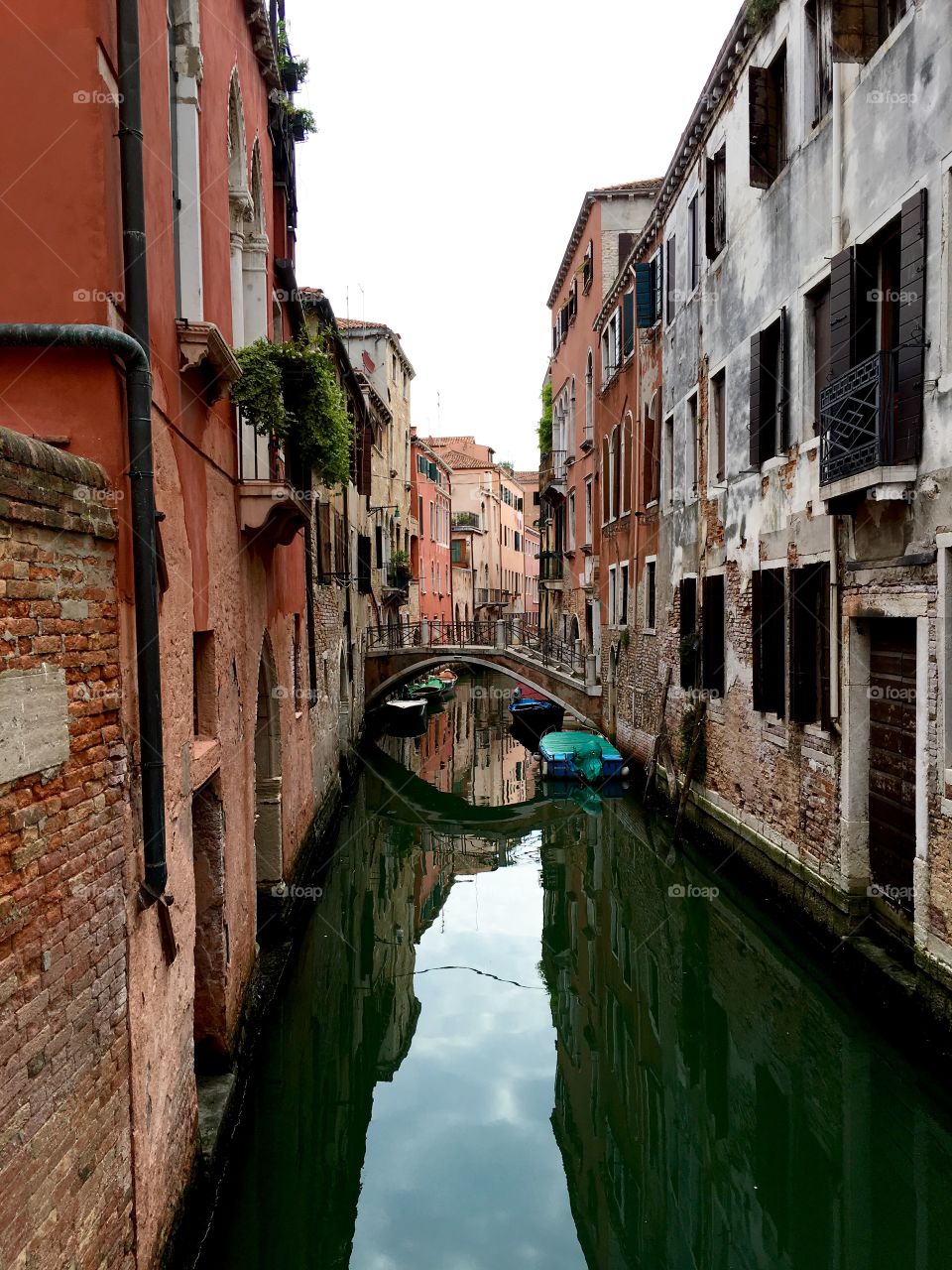 Canal walks in Venice during a hot summer day. 