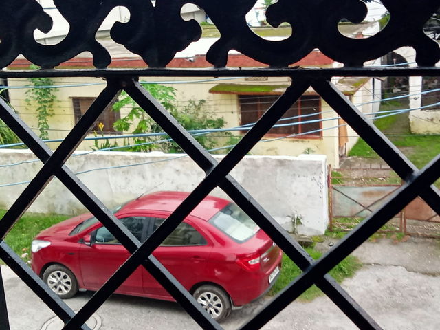 the parked car view through the grill of my balcony