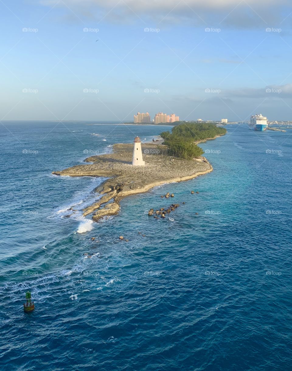 View from above of island and lighthouse in ocean water Caribbean Sea