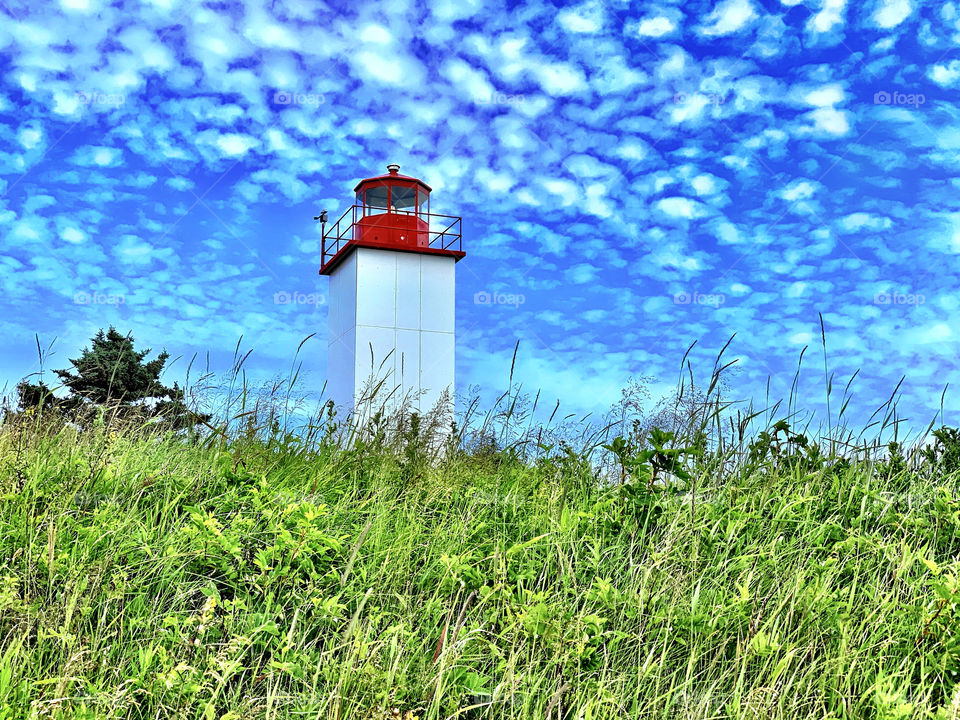Beautiful summer day in New Brunswick Canada with this lighthouse and beautiful sky
