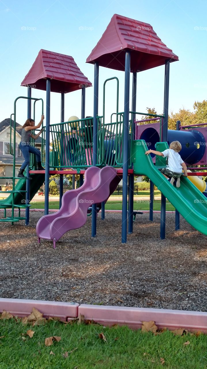 kids playing in the park on a warm and sunny fall day