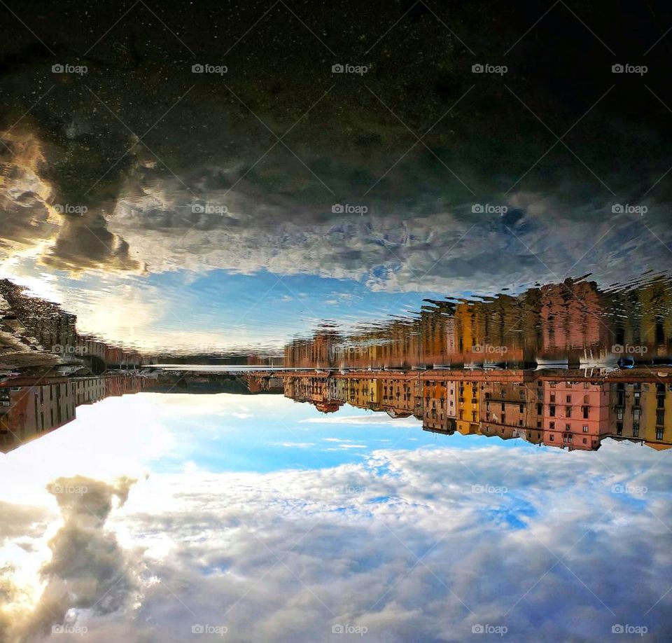 starry sky on a reversed life. sky and houses reflected on river.