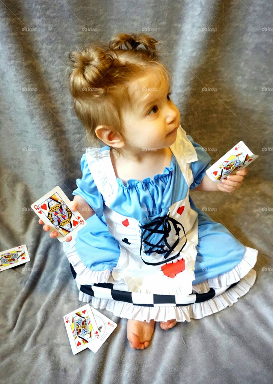 Cute baby holding play card in hand