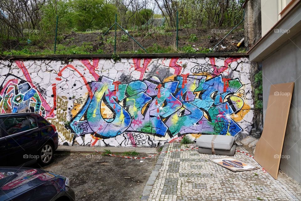 Colorful abstract graffiti and lettering on the wall by the path near Vitkov in Prague, Zizkov.