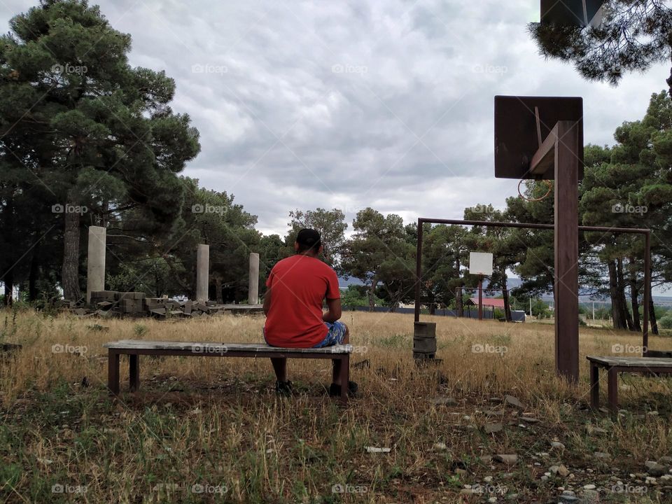 A boy in an unattended stadium