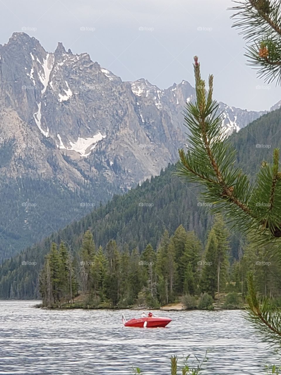 red boat in mountain lake