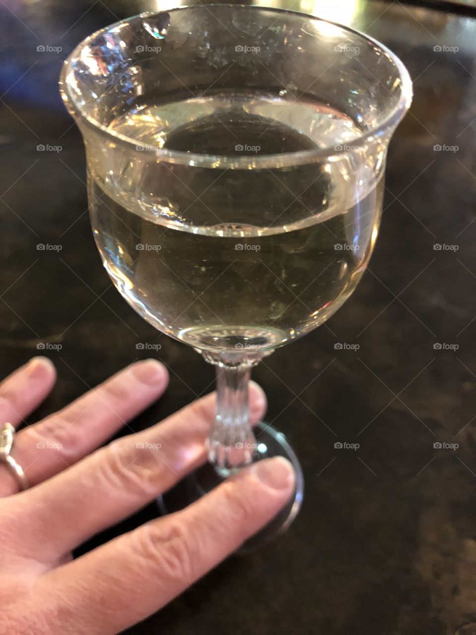 Tiny wine glass with hand