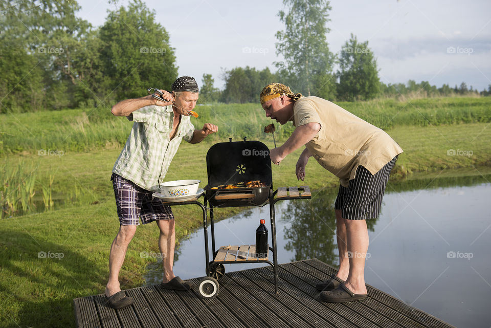 Two attractive men at the grill