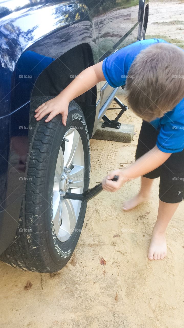 Boy changing tire 