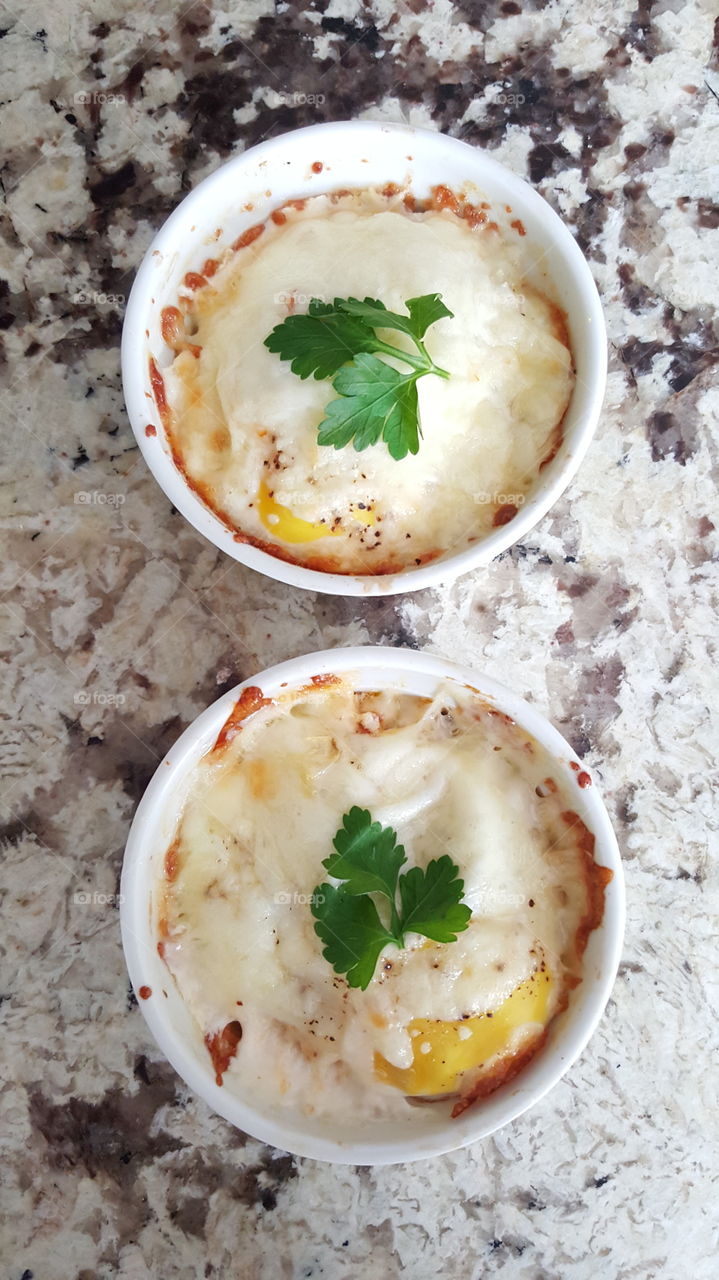 High angle view of baked eggs and cheese