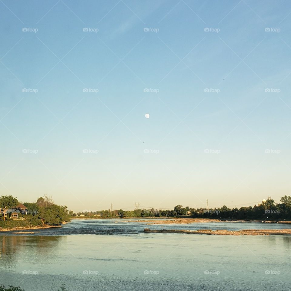 The moon shines on the river