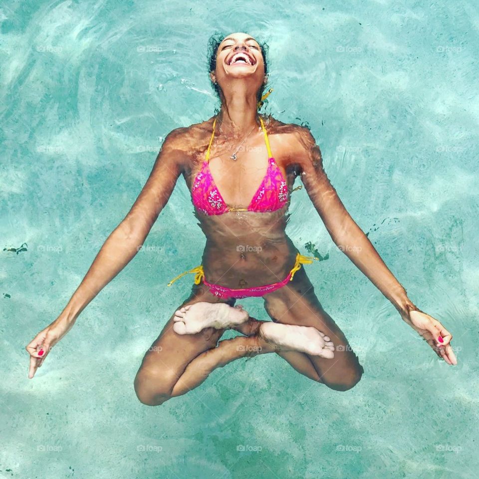 Woman doing yoga pose in water