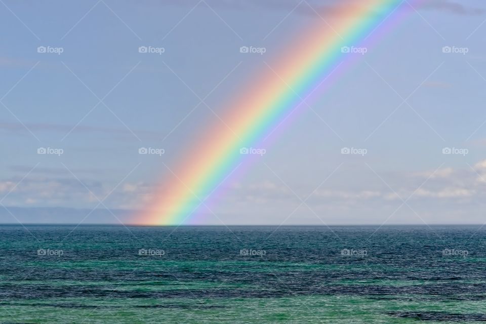 Brilliant vivid Rainbow over the ocean 