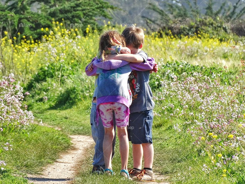 Brothers Giving Big Sister A Hug