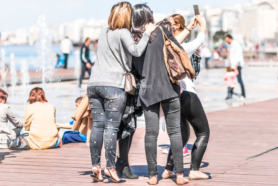 Group of friends taking selfie on mobile phone