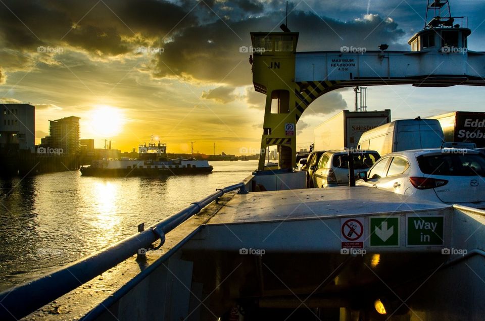 Woolwich ferry on the river with a sunset