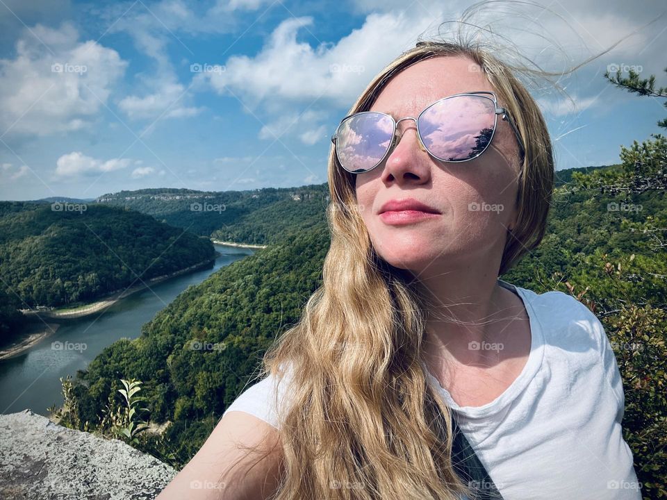 A blonde woman enjoying the views from Buzzard Rock in Whitley City in Kentucky 