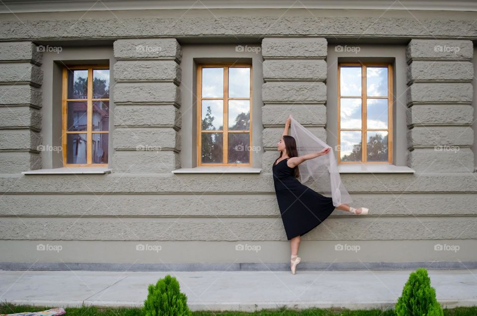 Young Female Ballerina Dancing Outside with Scarf