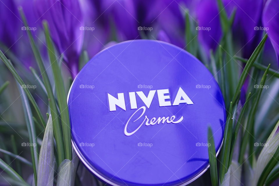 nivea cream among blooming crocuses