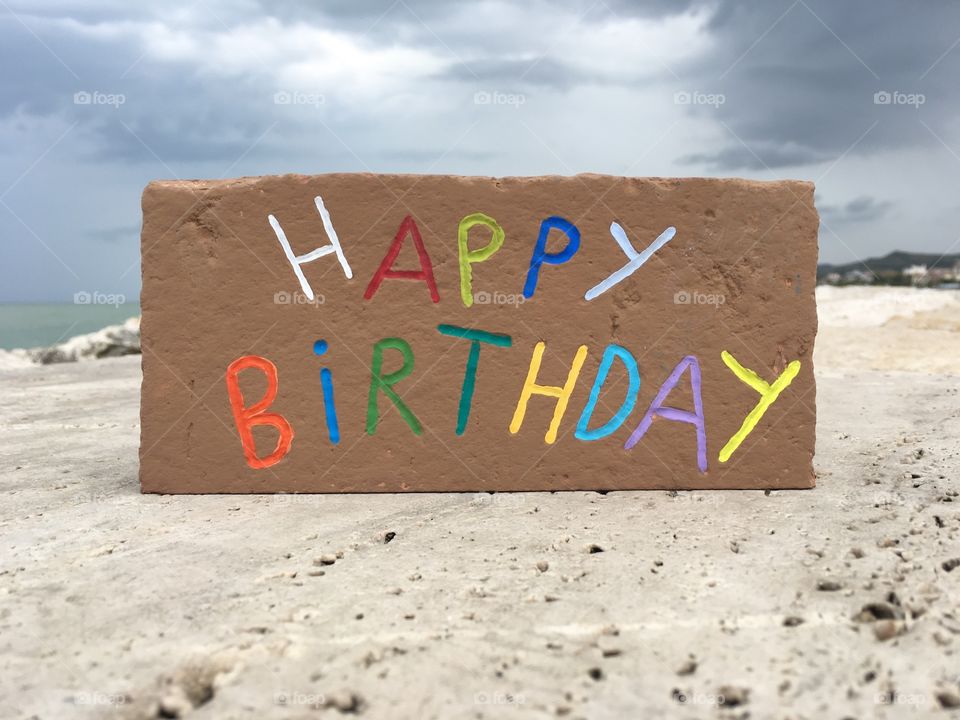 Happy Birthday message carved on a brick