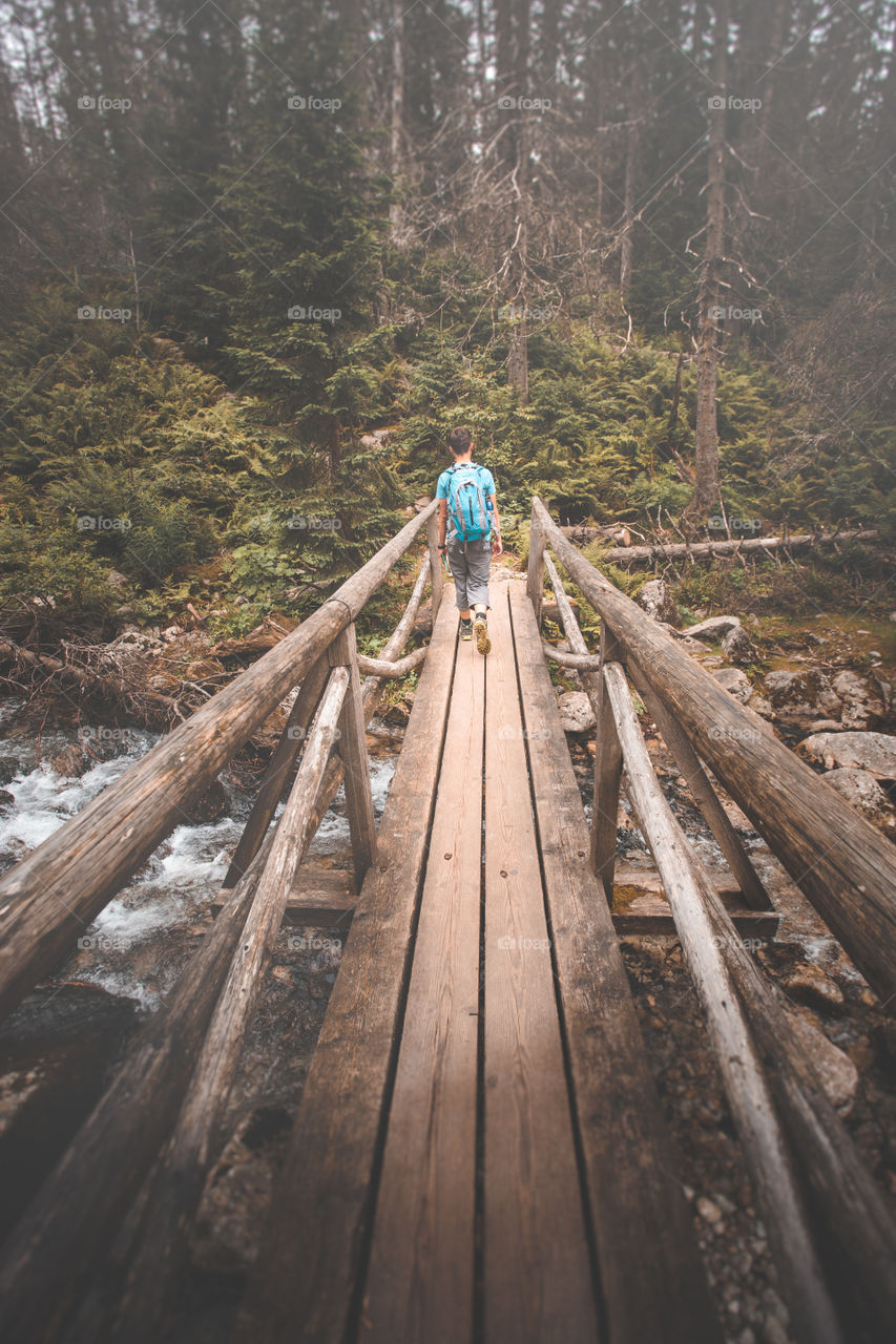 Man walking on footbridge