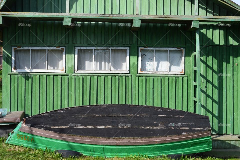 green building and green boat