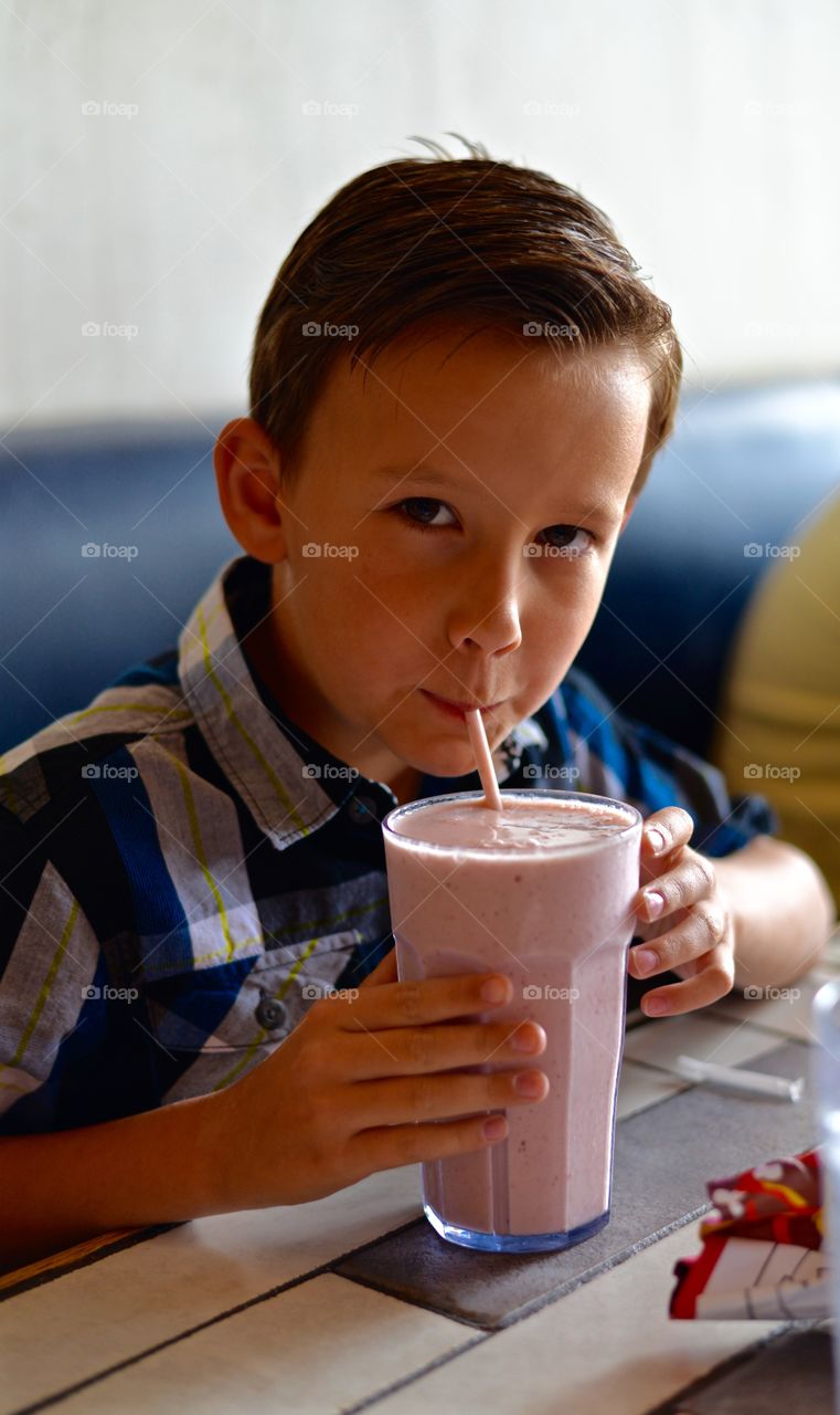 Young man enjoying his fruit smoothie 