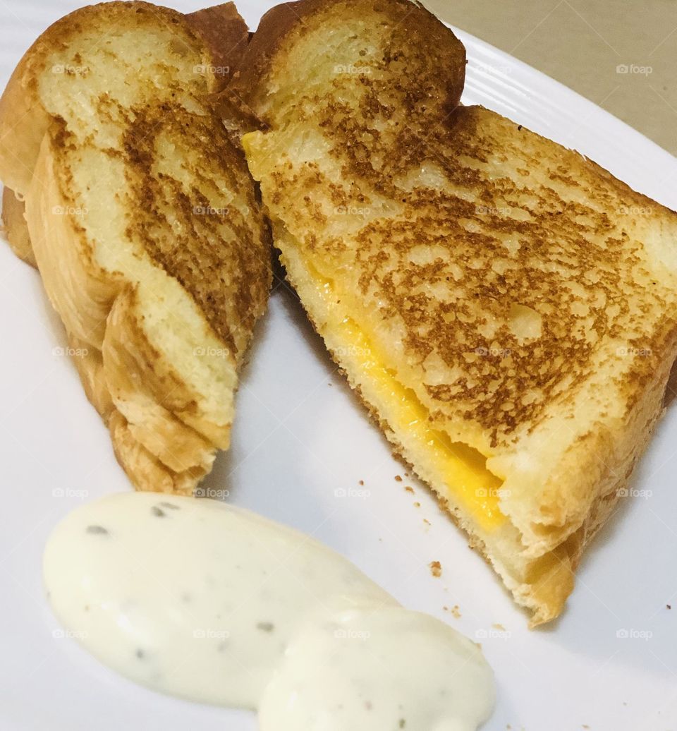 Yummy grilled cheese slice sandwich with ranch dressing dip