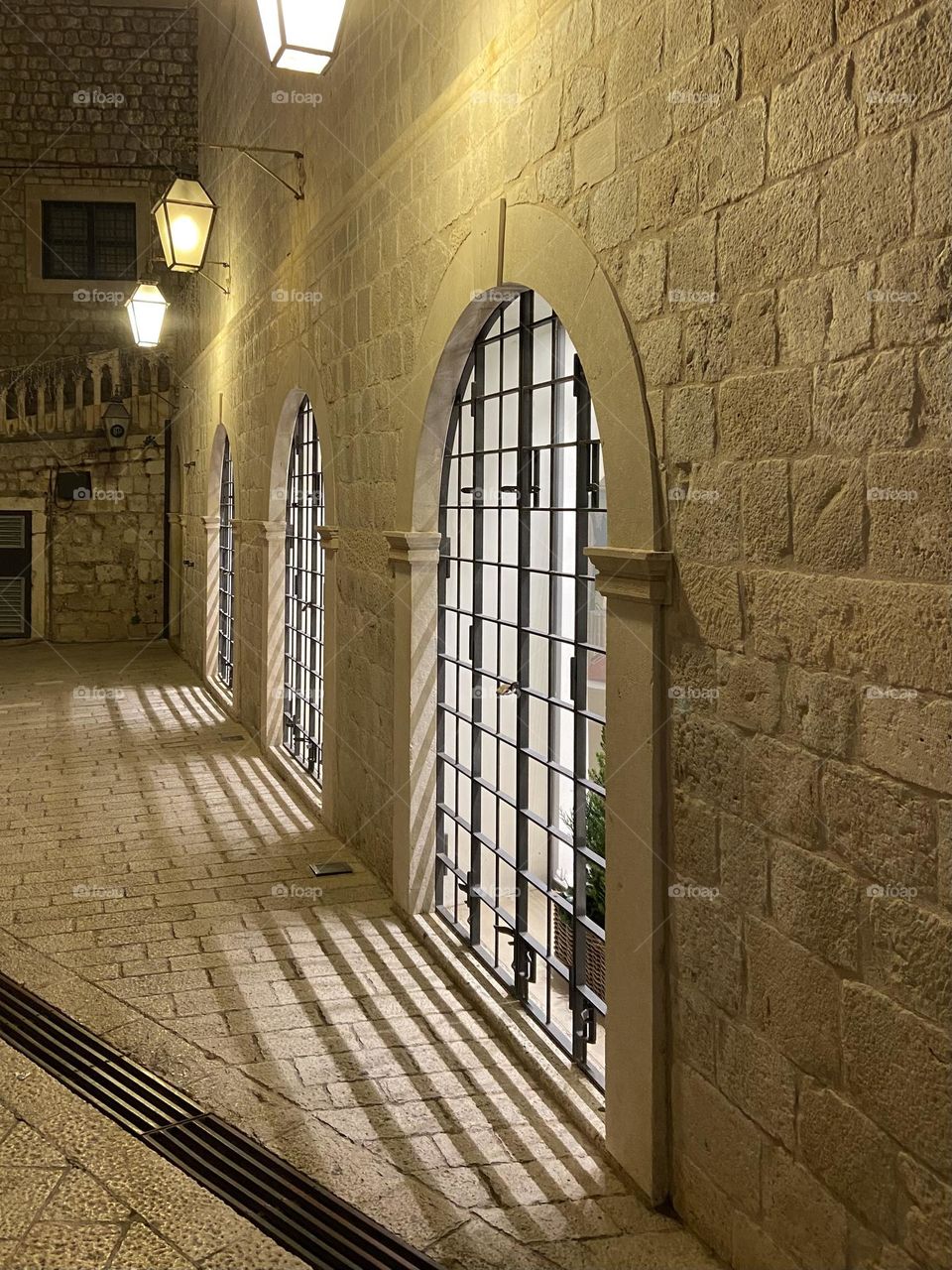 In the historical walled city of Dubrovnik, an evening walk is made magical by the lights in windows.