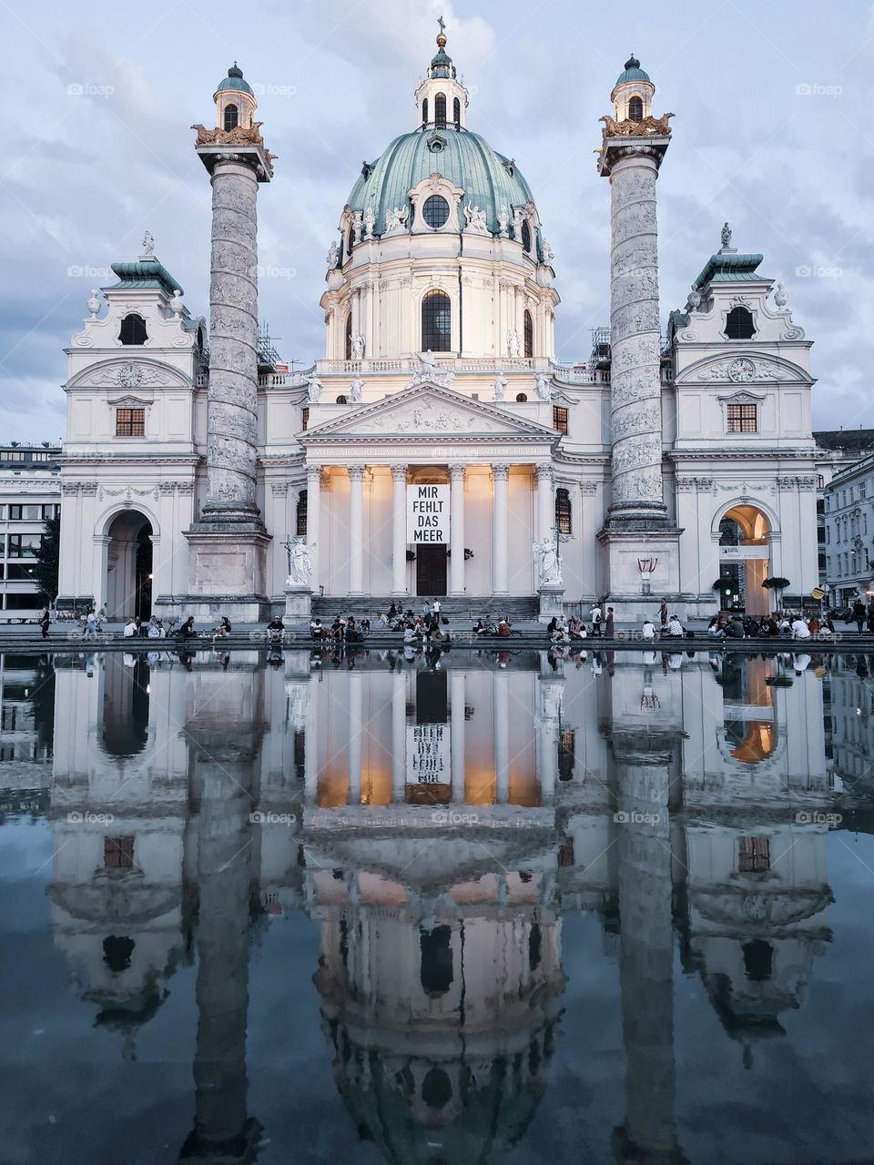 church reflection in the water, with clouds above