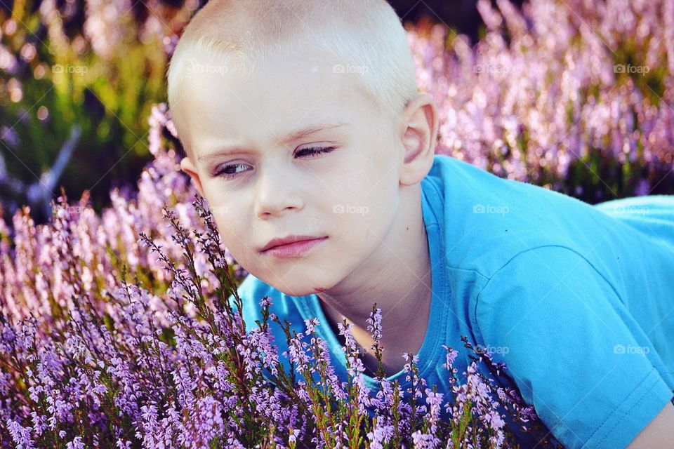 Boy looking at the flowers