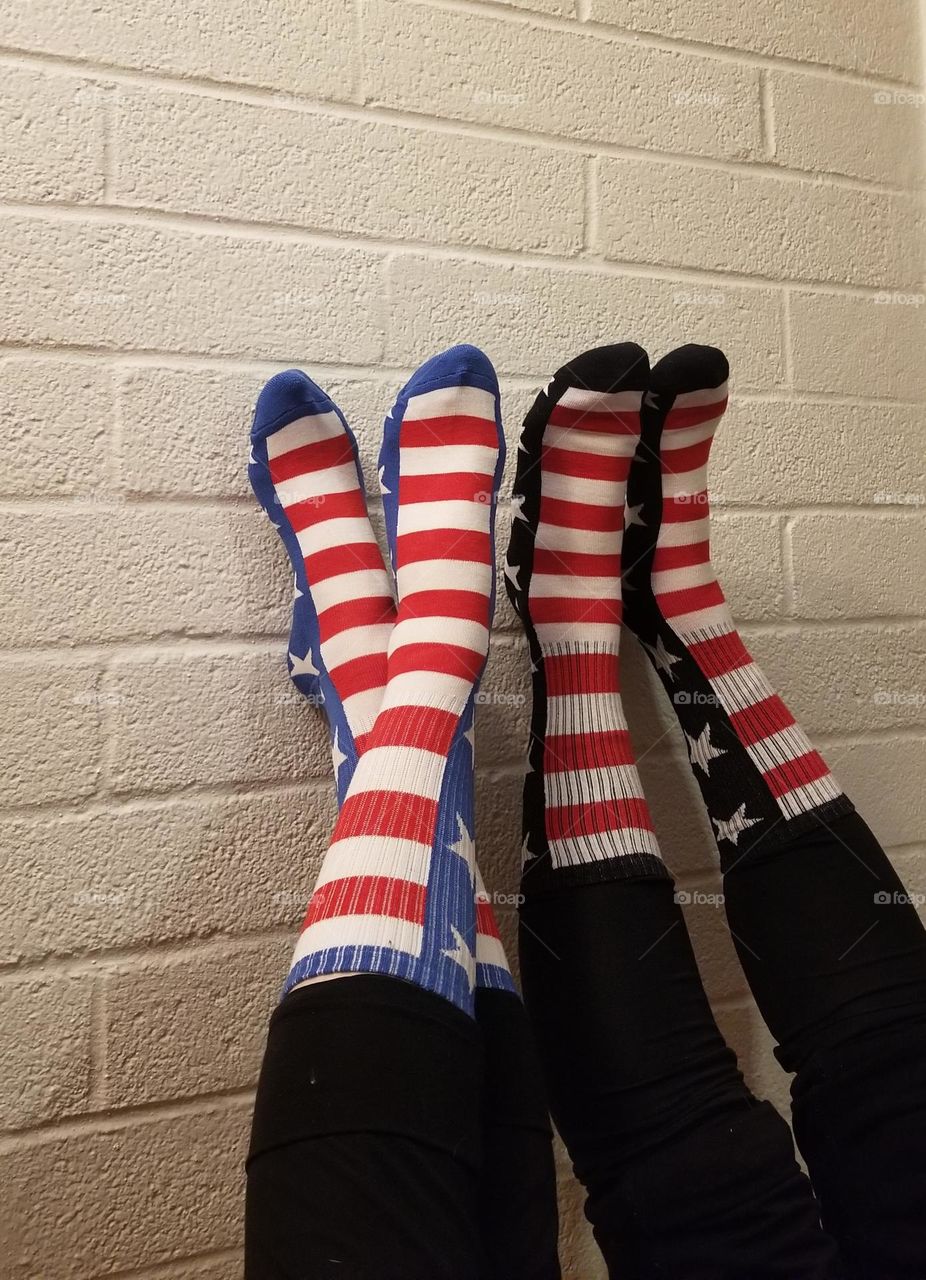 Popfizzy American flag socks on brick background.