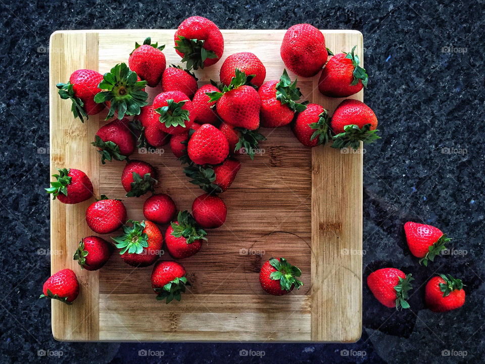 Strawberries on a wooden cutting board