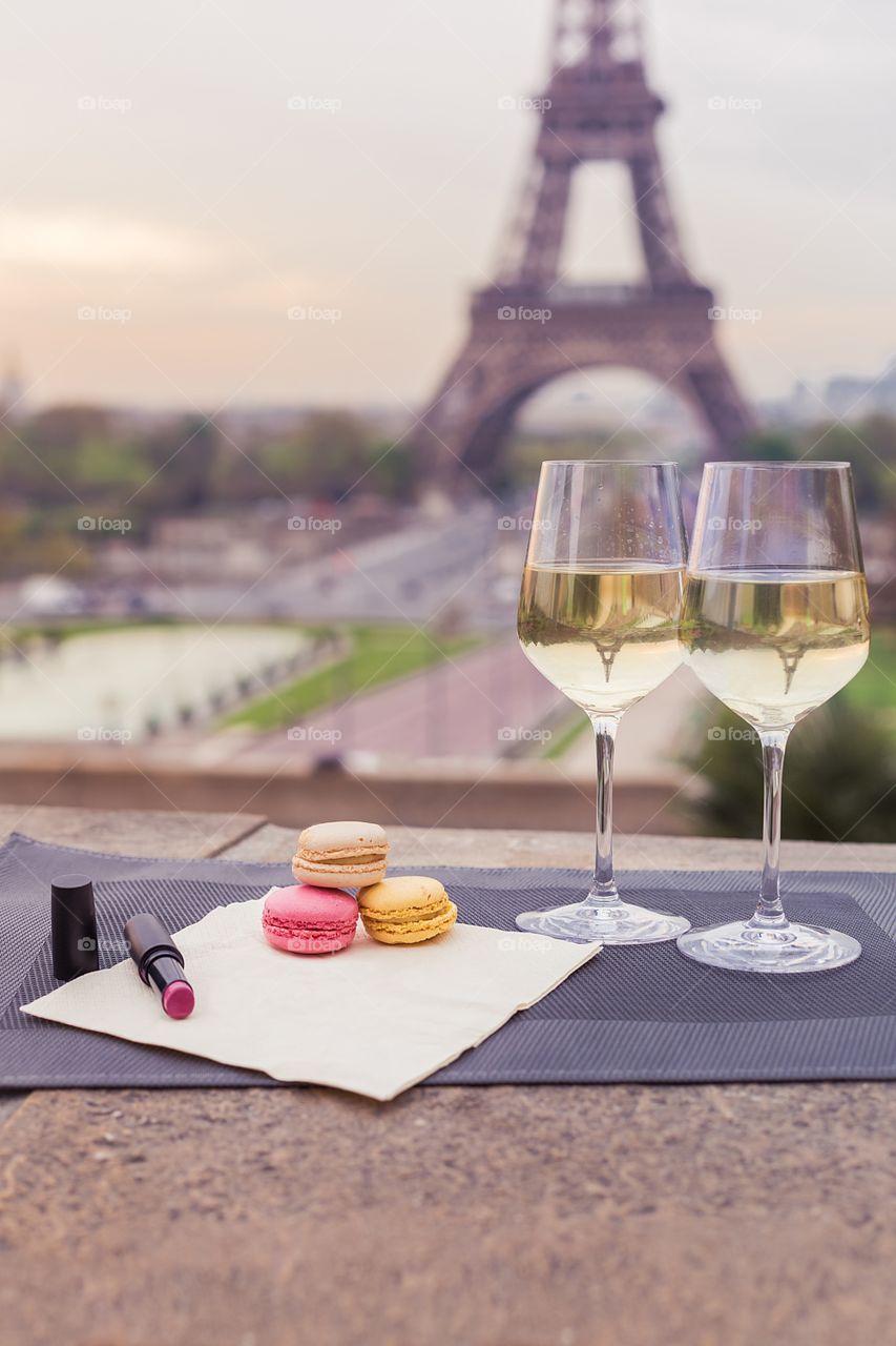 Wine glasses with croissant on the Eiffel Tower background 